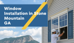 A construction worker in a white hard hat is on a ladder, installing a new window into a light-colored residential home. In the background, the iconic Stone Mountain rises prominently, surrounded by trees and other houses under a clear blue sky. The image features a badge blue and canary yellow overlay with the accurate title "Window Installation in Stone Mountain GA" in white text.